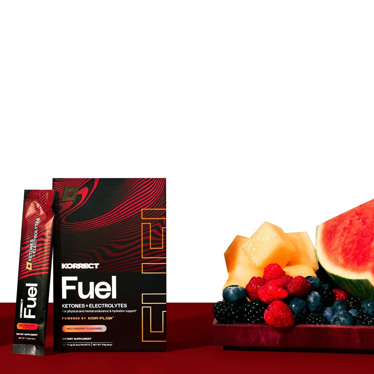 Korrect Fuel box and stick packet next to melon, watermelon and berries